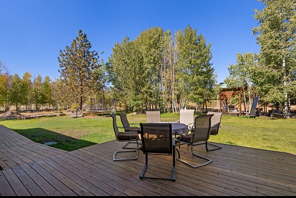 table and chair set on back deck of main house