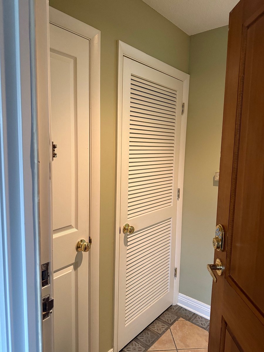 Entryway coat closet and utility closet with new water heater.