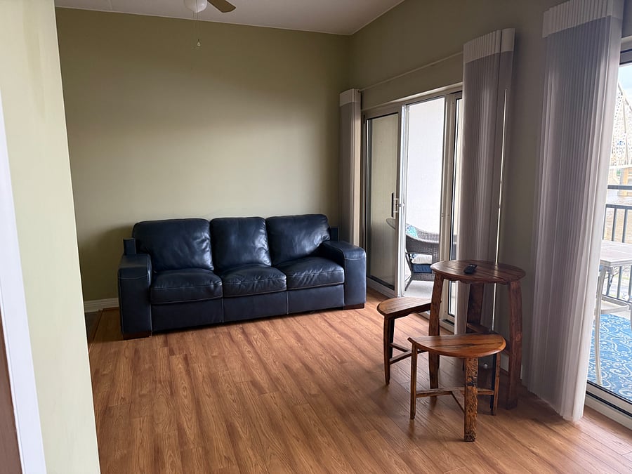 Leather couch and bourbon barrel stools w table. Electric blinds operate by remote at entry door.
