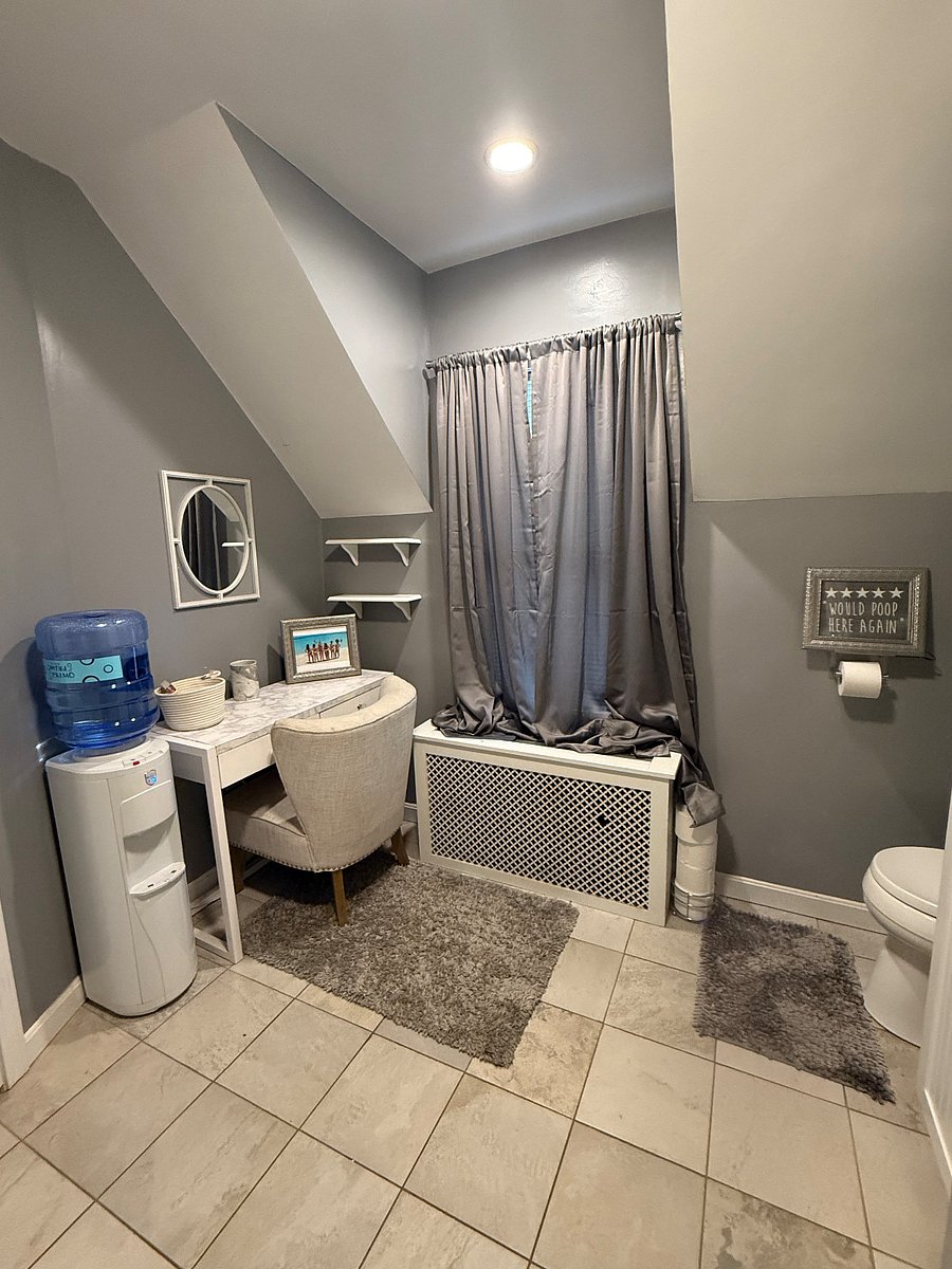 Spacious full bath, with two vanities, tub/shower combination.