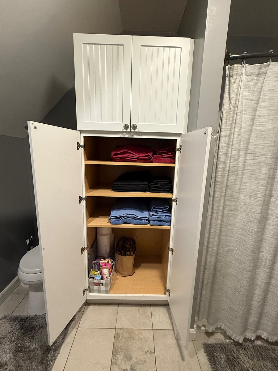 Shared bathroom linen closet, with supplied bath linens.