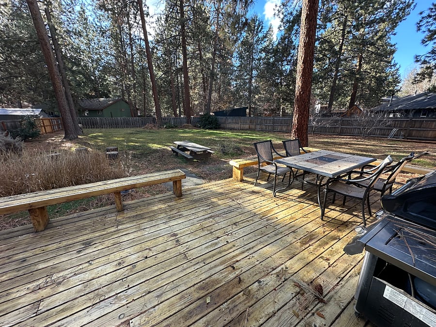 Back deck, with BBQ, fire pit, outdoor table and chairs, and picnic table.