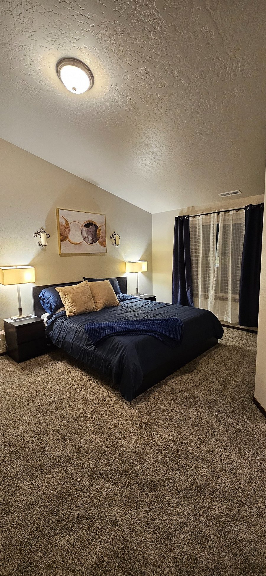 Master bedroom with comfortable King Size Bed. Two Night Stands, Two Side Table Lamps With On/Off Switch and Plug in receptacles for easy phone or accessories charging 