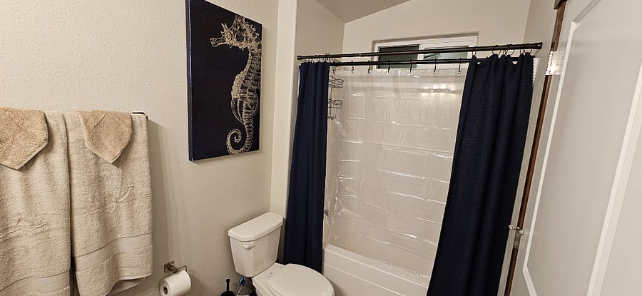 Full size bathroom with double vanity sinks, stand up shower with tub, all soaps and toilet paper provided