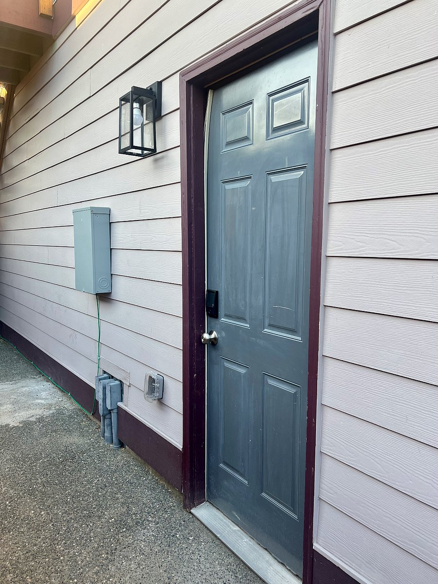Exterior entrance with pathway light and security lock.