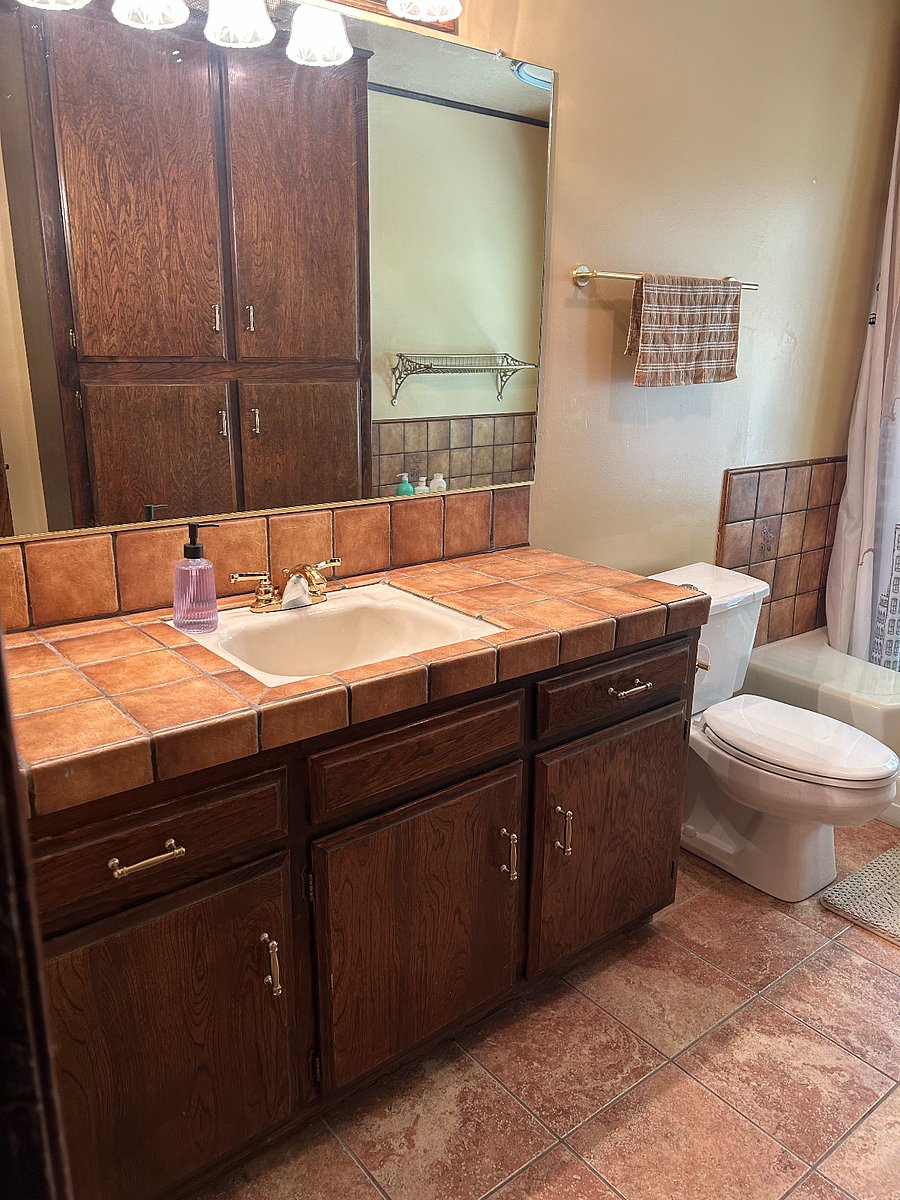 Large bathroom with sunken fiber glass tub is located near bedrooms 2 and 3.  