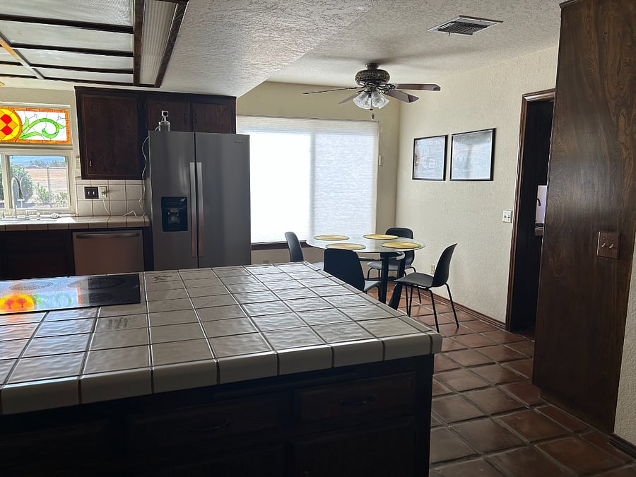 Kitchen with breakfast nook and entry to the laundry room.