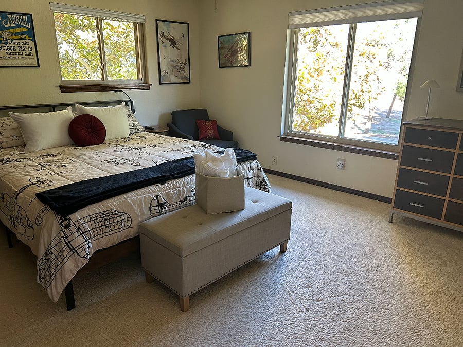 Bedroom #3 has a king size bed, charging stations, and comfortable chair.
