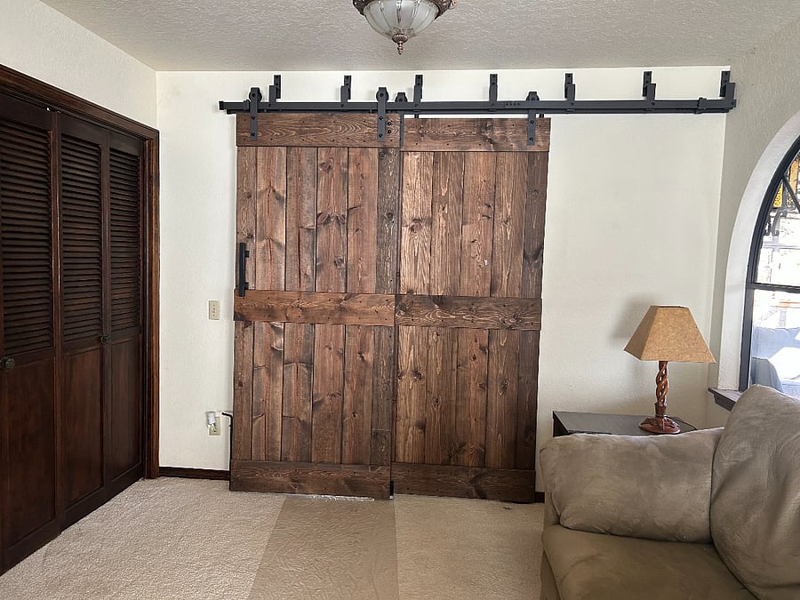 Master bedroom enclosed for privacy with a custom-made barn door.  The Master bedroom also has a single door to the hallway with a full length mirror.