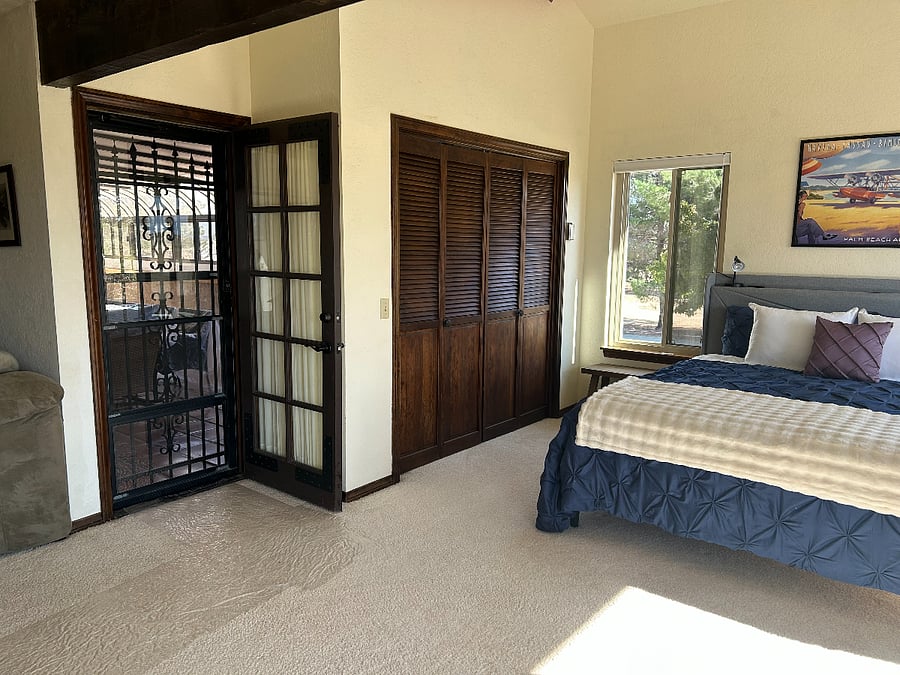 Master bedroom with access to the upstairs solarium.  Curtained door provides privacy.