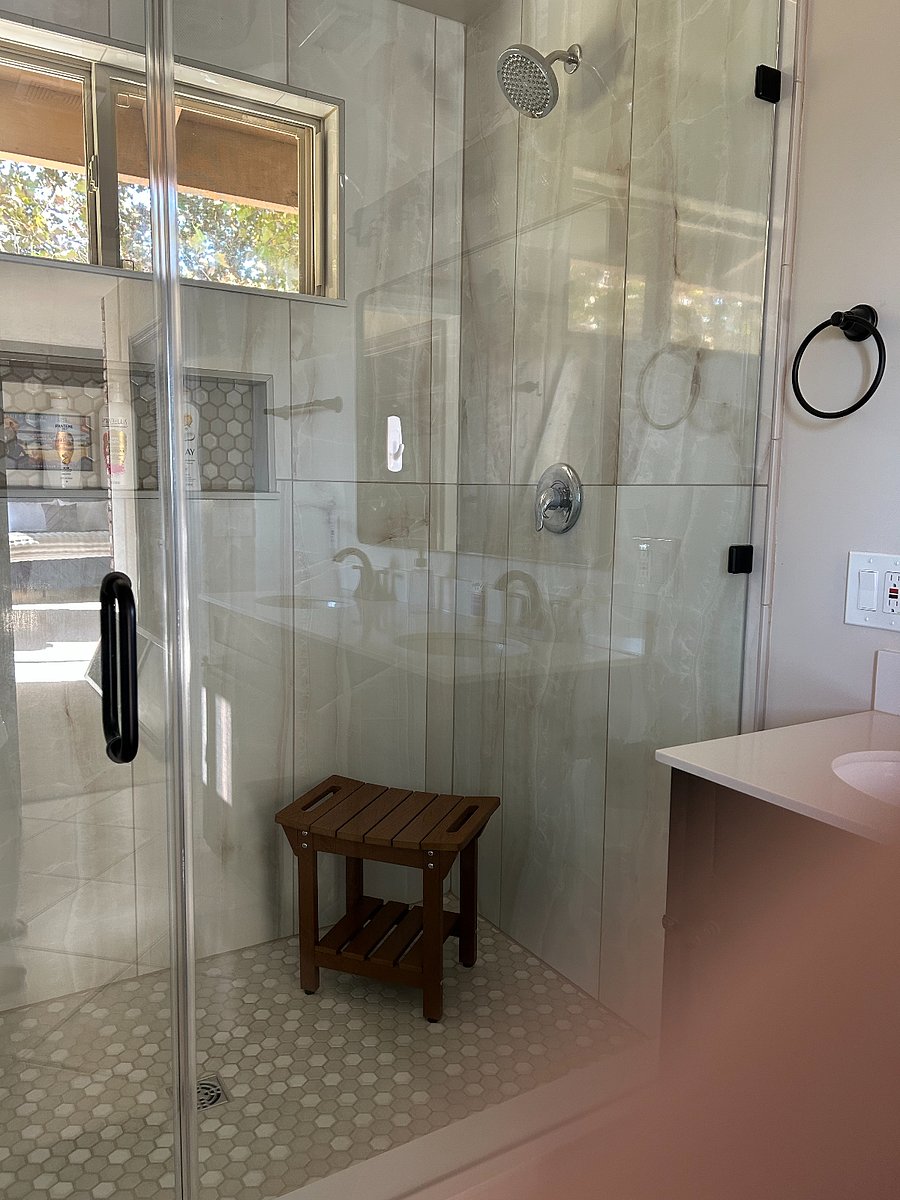 Beautiful shower with 2 spray nozzles and seat for your convenience.