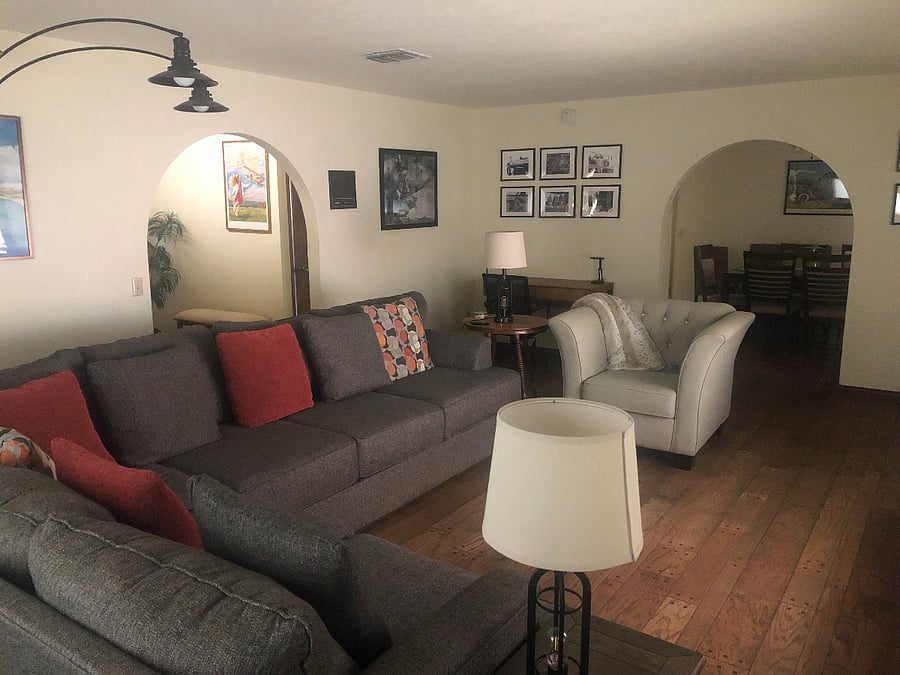 Entry to the living room is from the entry way and the dining room.