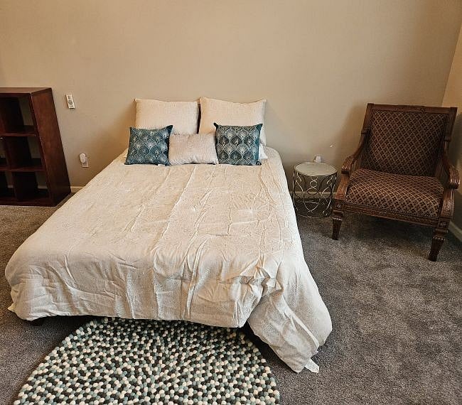 Purple brand hypoallergenic queen mattress.  The chair adjacent to the bed is very comfortable.