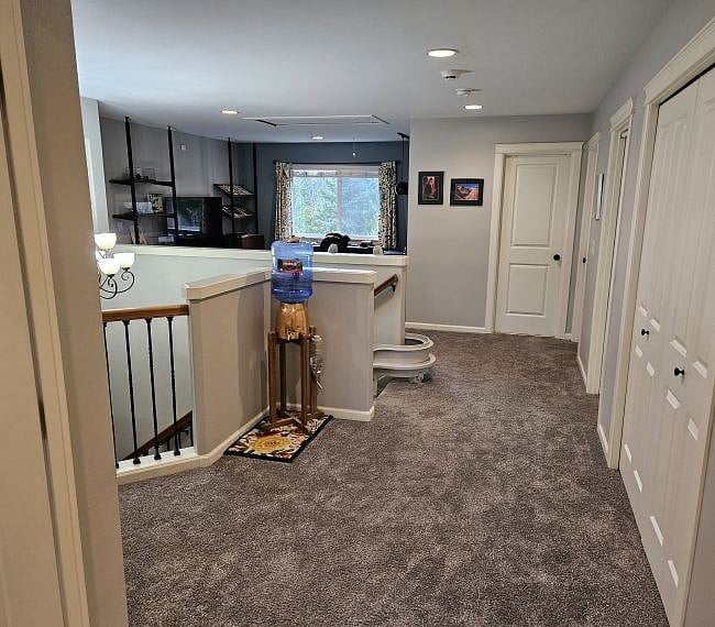 Hall and stairs viewed from doorway of master bedroom.  Bottled drinking water is available in the copper water cistern next to the stairs.