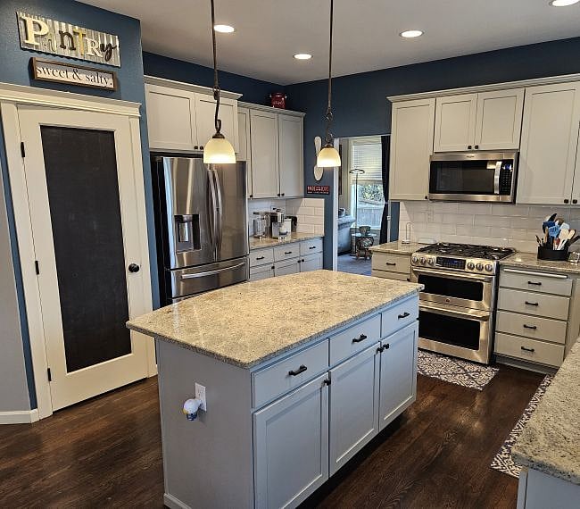 Front left to right: walk-in food pantry, counter-depth fridge and coffee bar area.