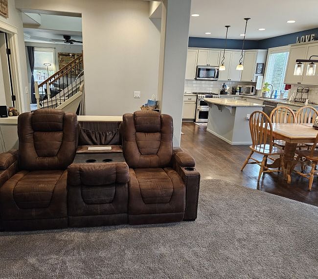 The center of the couch can fold down and serve as a table / arm rest with cup holders.
