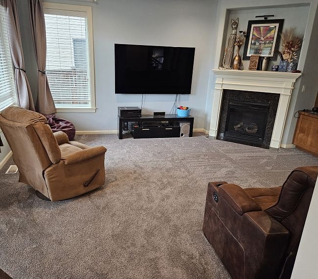 Family room / audio video entertainment area / library.  Adjacent to the dining area.The center of the couch can fold down and serve as a table / arm rest with cup holders.