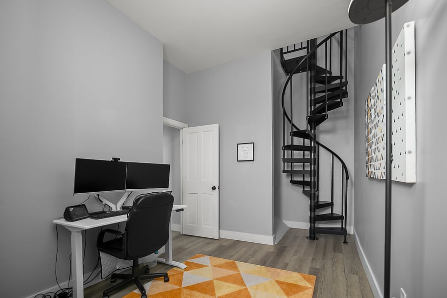 Office with stairs to attic bedroom