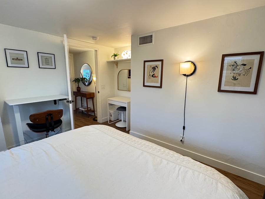 Bedroom with standing desk and vanity/desk