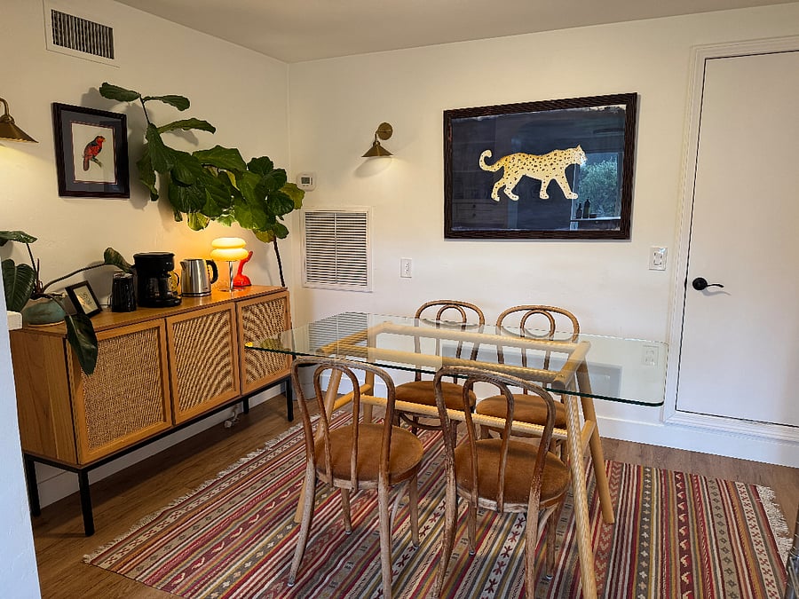Dining room, complete with coffee maker, kettle, dishes, glasses, wine glasses, mugs, linens. Also door is to the pantry