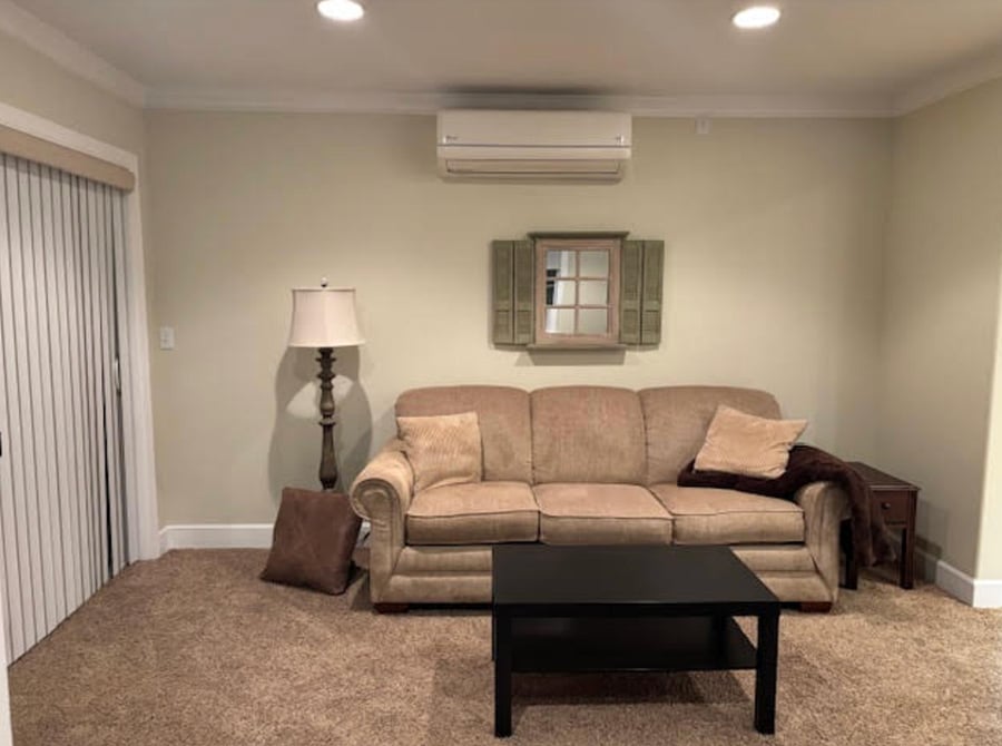 Living room with heating and AC unit.