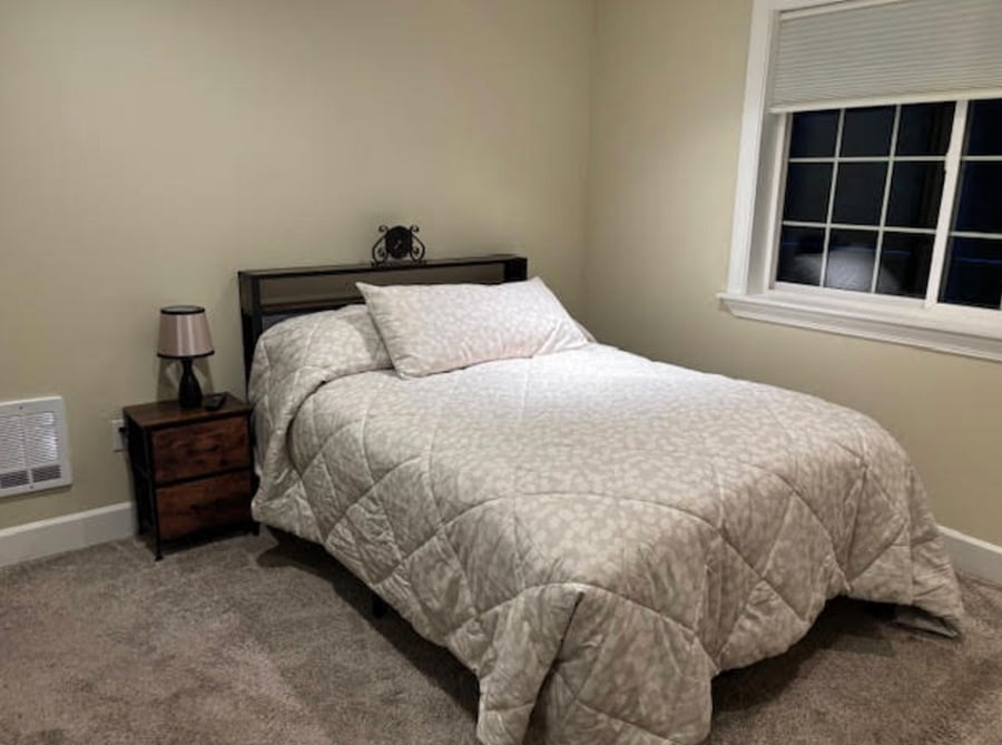 Main bedroom with full size bed and blackout shades.