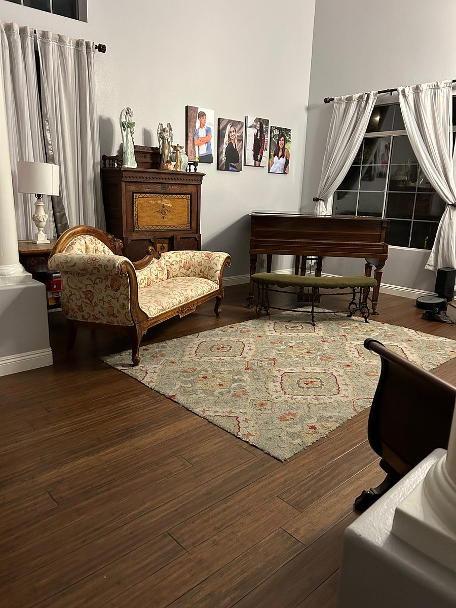 Living room with baby grand piano. 
