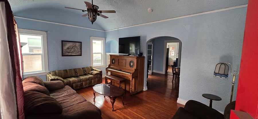 Living room with TV station, couches and recliner chair