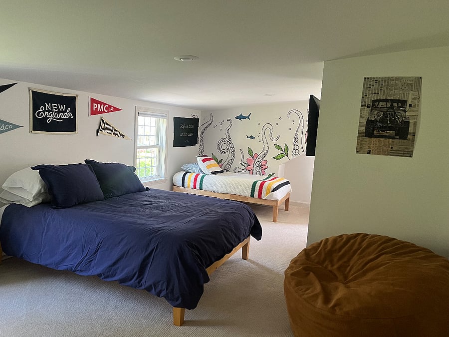 Upstairs Bedroom with Queen Bed and Two Twin Beds. Bedroom also includes Smart TV & Desk.