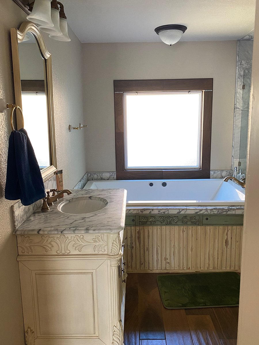 Purple Room ensuite bathroom with soaker spa tub and shower, two sinks