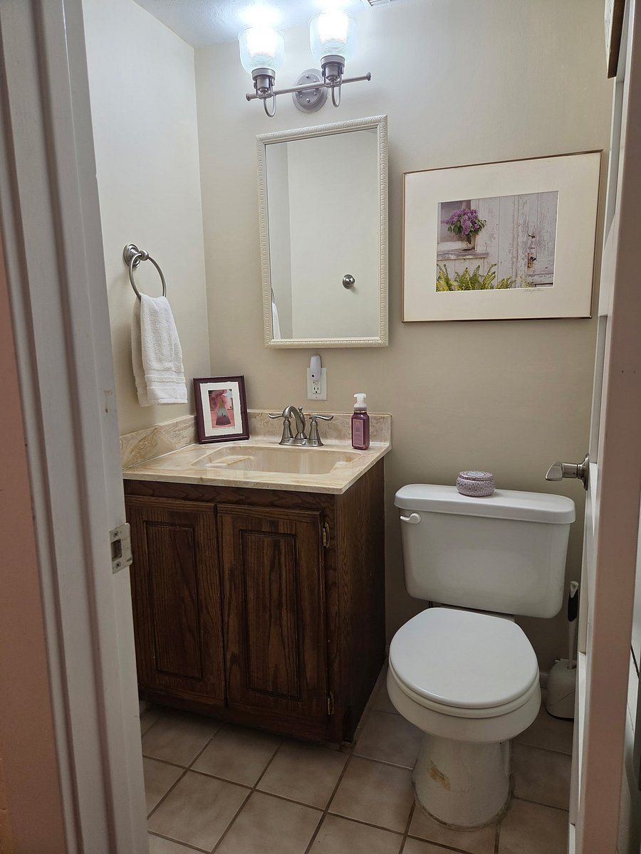Private powder room across from laundry room.