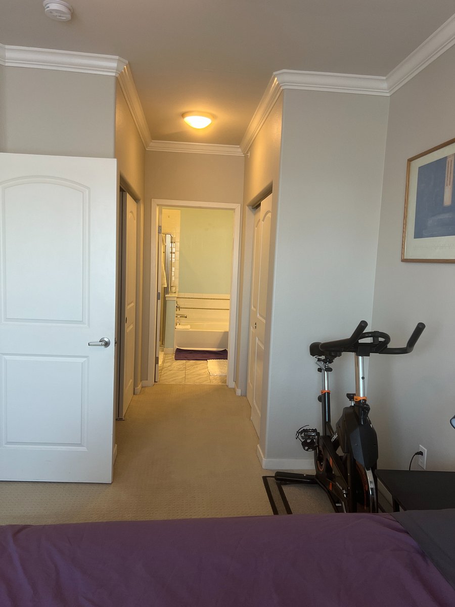 Bathroom with shower and full sized tub. 2 large closets on either side walking into bathroom.