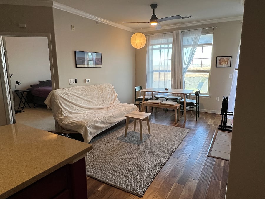 View from kitchen into main living space and into part of the bedroom.