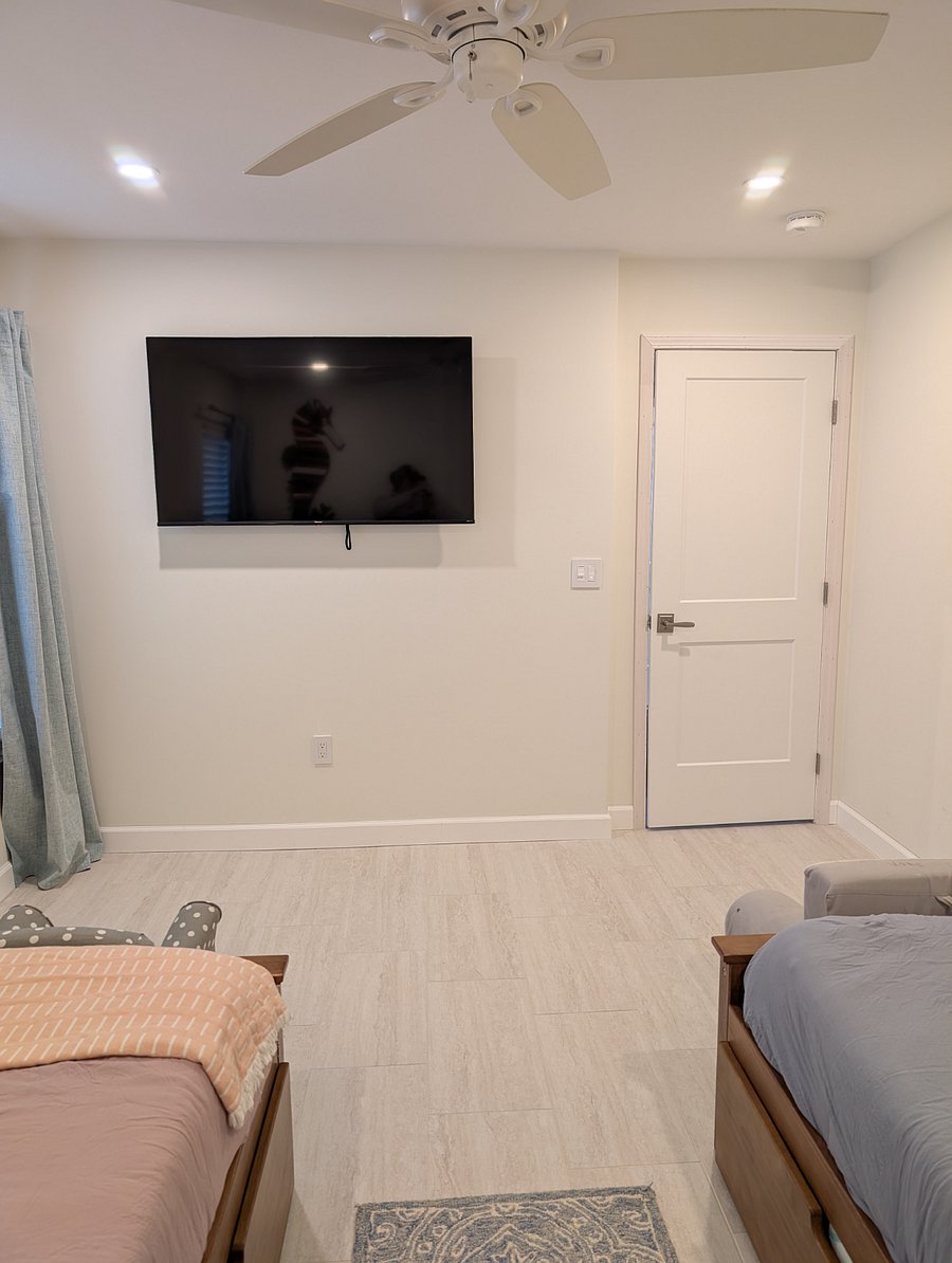 wall mounted smart TV in second bedroom