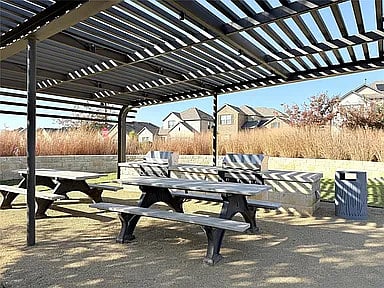 Arbor covered seating for picnics and watching kids play on playground