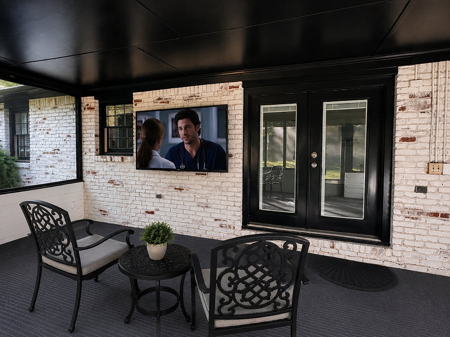 Screened in backyard patio with TV and outdoor furniture