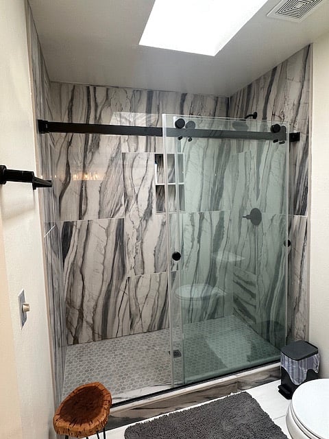 Master bath with skylight allowing natural lighting .