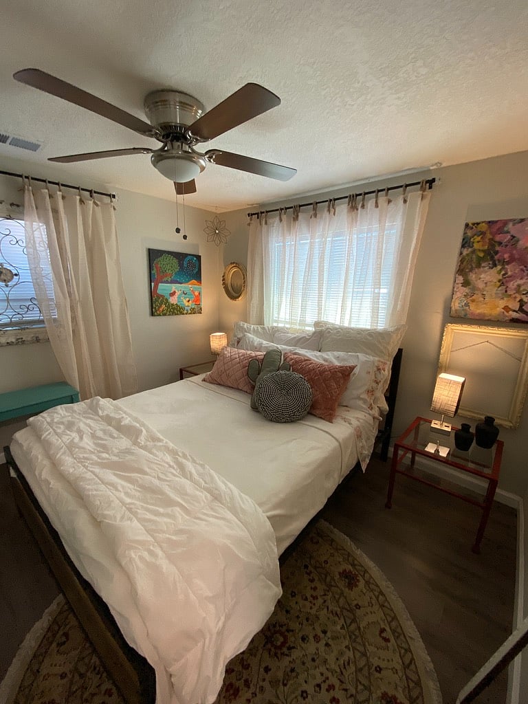 Queen bed with vintage, cotton sheets & cozy duvet and blankets. More local artwork.