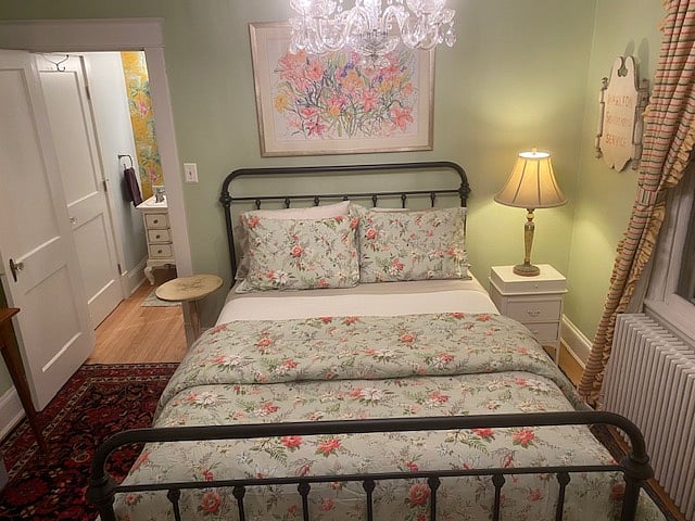Third bedroom has a queen bed, small Roku device TV, and desk overlooking the front.