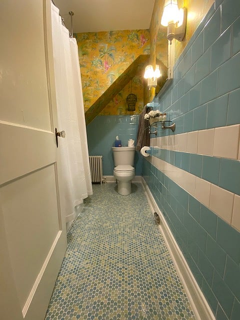 The most unchanged room in the house with vintage Tiffany Blue tile, cast iron D shape tub/shower and commode.