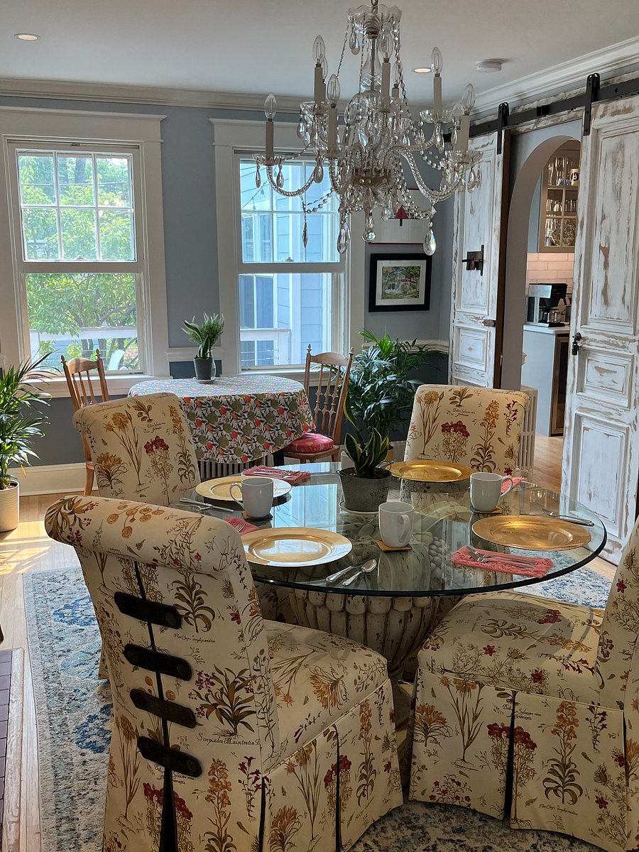 Dining room with wood burning fireplace. The fireplace adds cozy charm, but is for decorative purposes only and cannot be used.