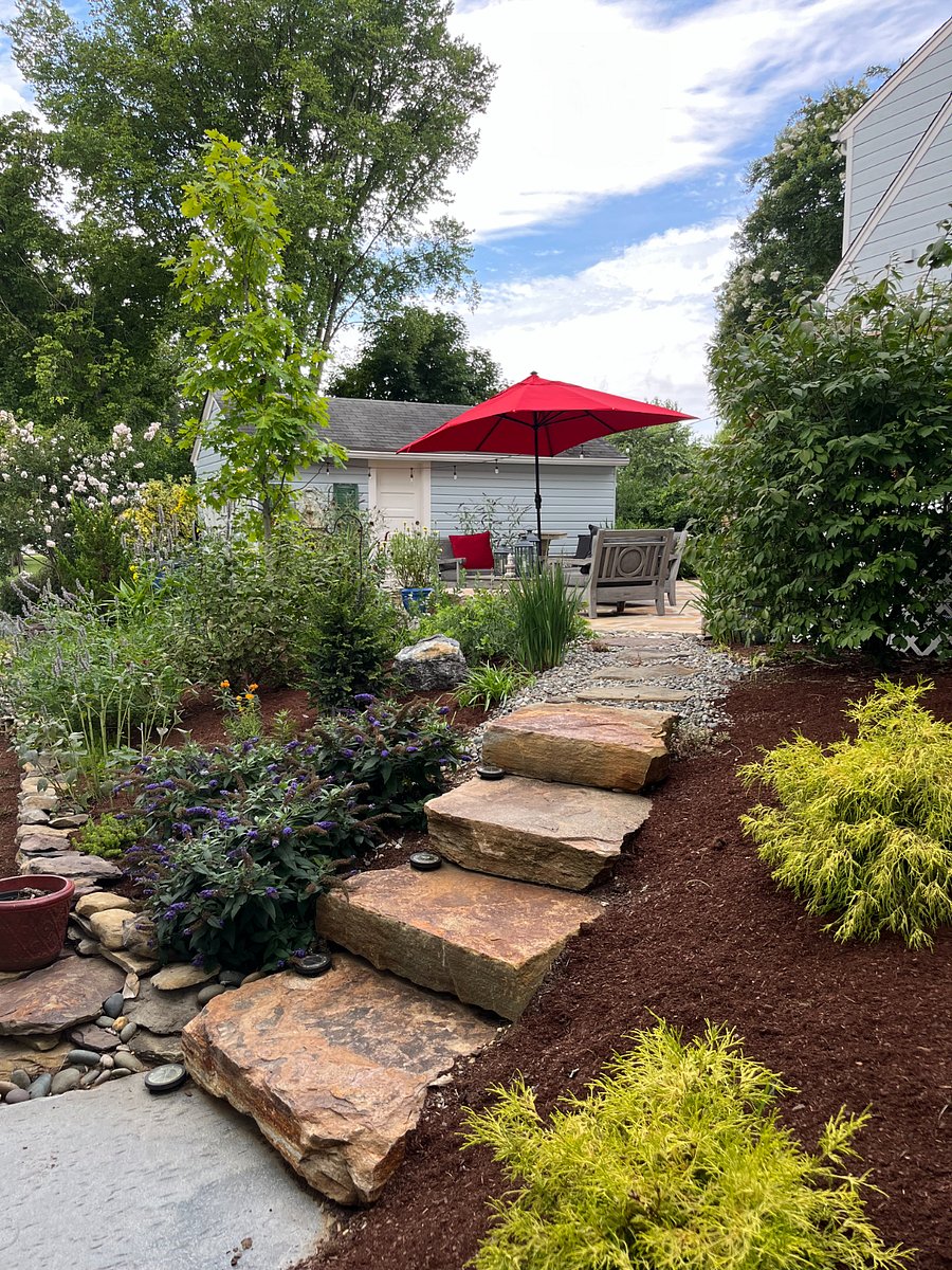 Natural stone steps (some uneven) lead from the side street to our backyard.