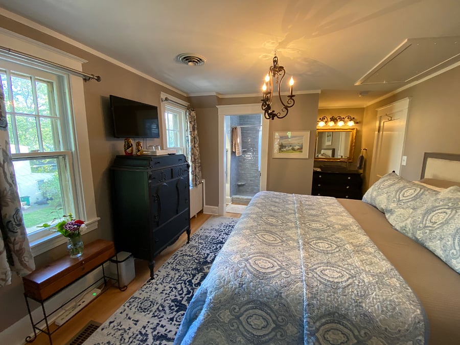 Second King Bedroom with en-suite bathroom, small closet, 2 dressers and a mid size smart TV.