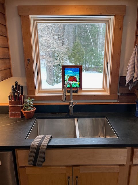 Looking east at kitchen sink, past the owner's artwork