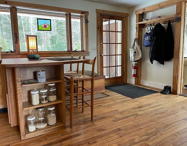 View from the TV room passageway into the kitchen towards the front door entry.