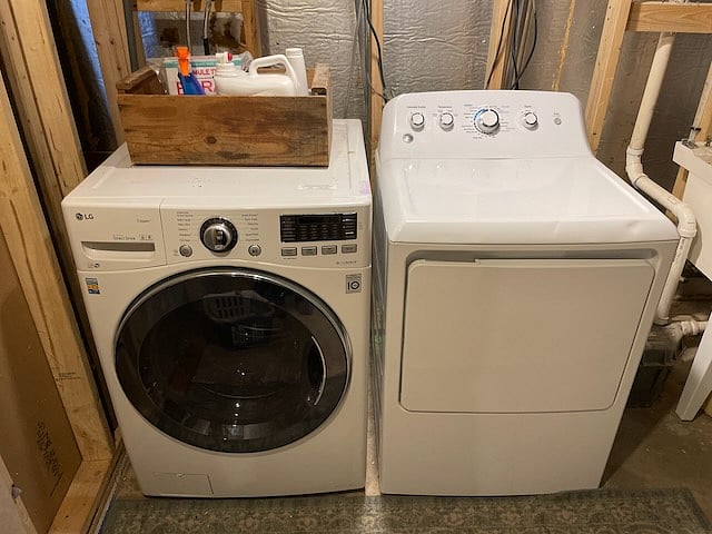 The laundry area with new appliances is downstairs. The downstairs, originally a full size basement, is being renovated into art studios and a living space.