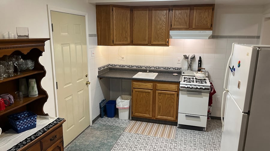 Fridge is full size. The door on the left is to the garage. 