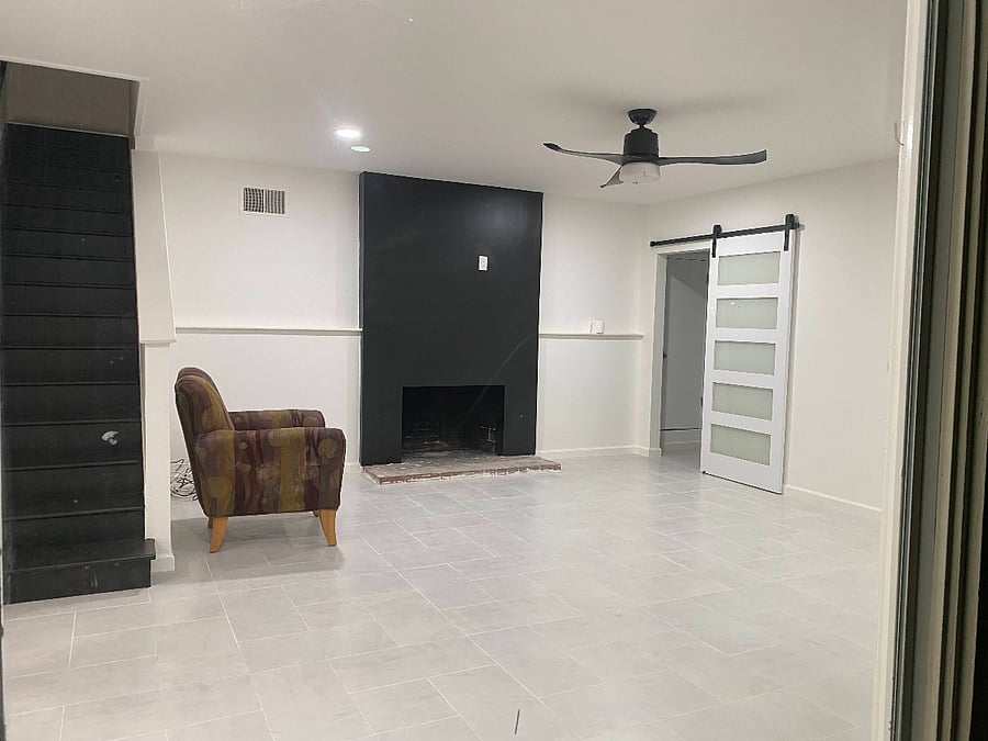showing: living room (unfurnished), doorway to bedrooms and bathroom and non-accessible stairs.