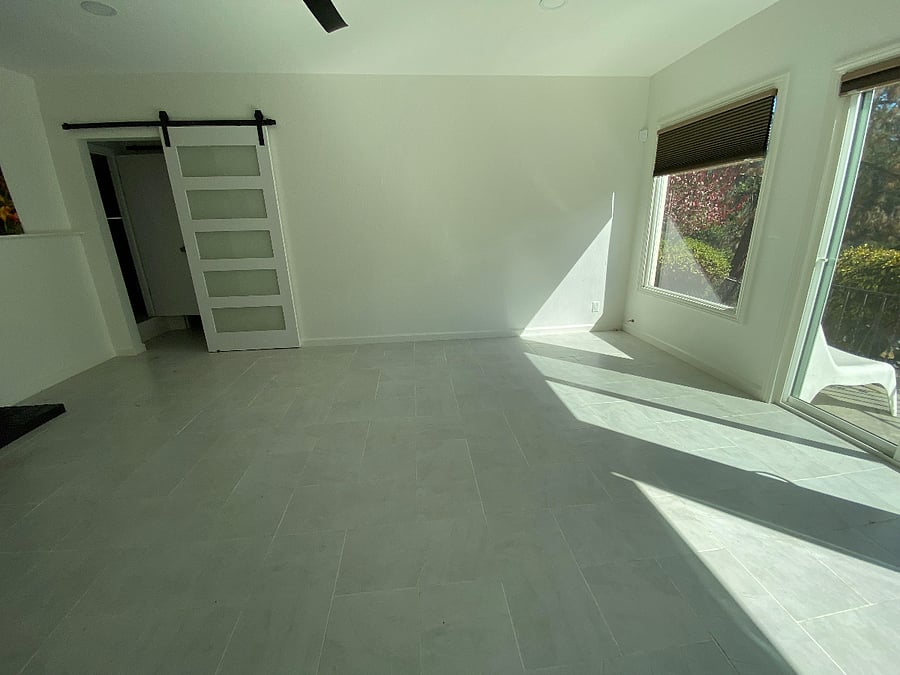 view of Living Room (unfurnished) and farm door to bedrooms and bathroom from kitchenette. 