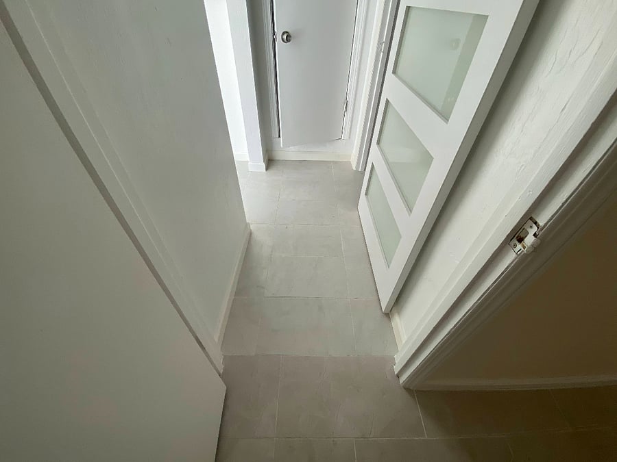hallway connecting second bedroom and bathroom (bathroom has farm door also)